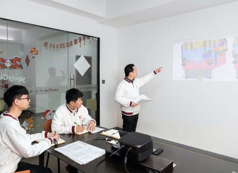 3-4 R&D staff discussing the development of molds in the conference room