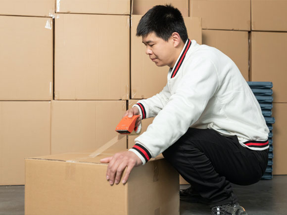 Worker is packaging the product using the paper box